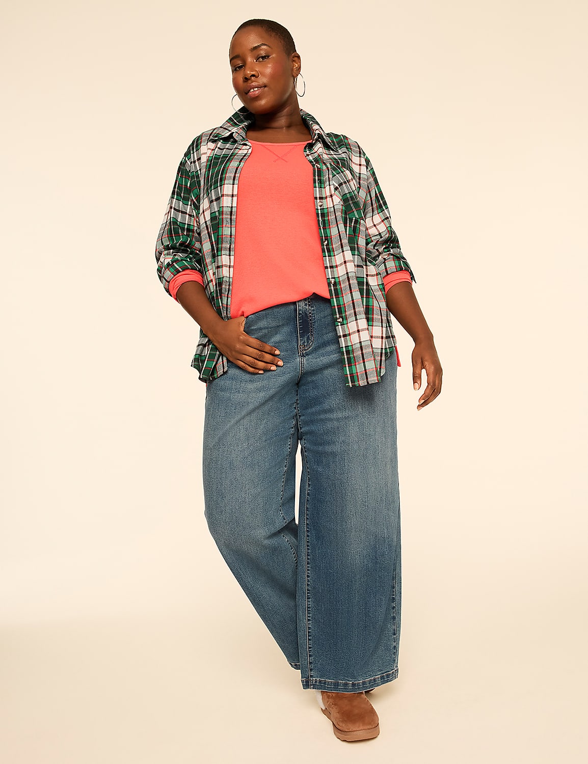 A woman wearing a green plaid shirt over a red top and wide-leg blue jeans stands against a plain, light-colored background. Product Image 3