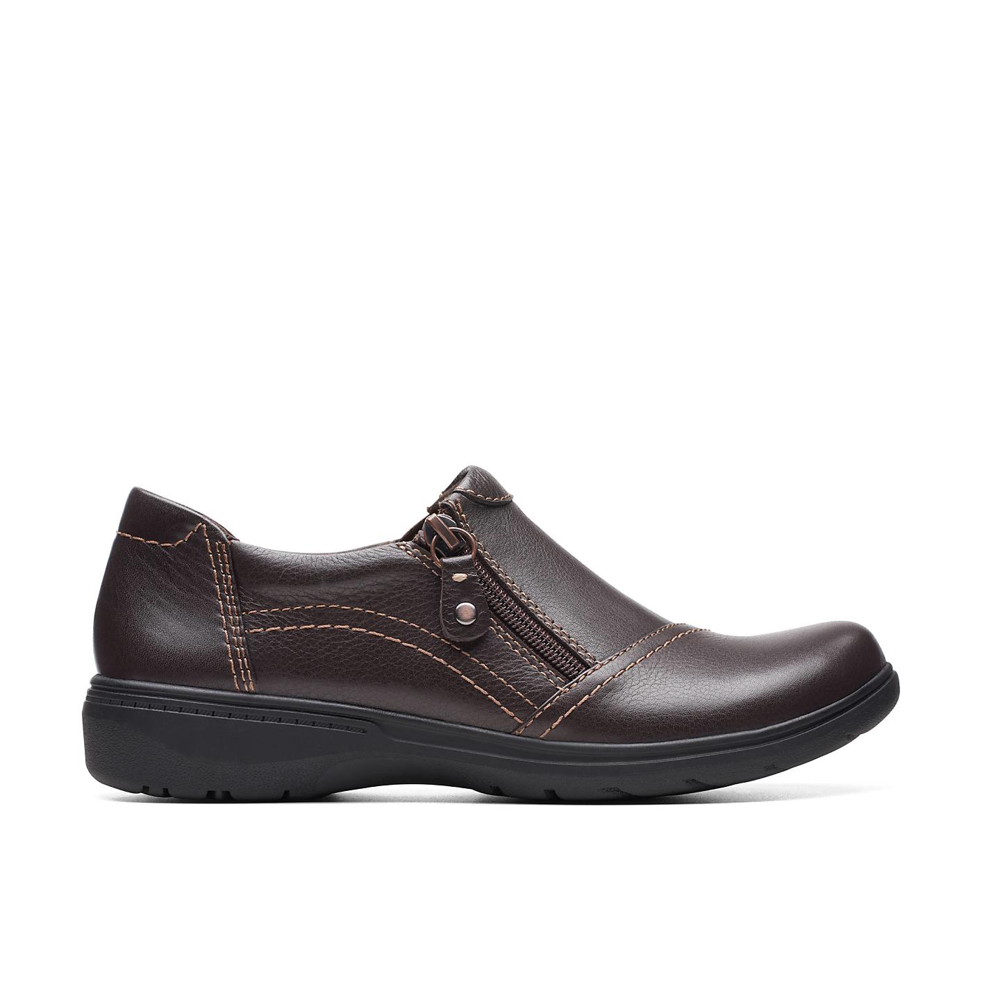 A brown leather shoe with a zipper sits in the foreground against a plain white background. Product Image 1