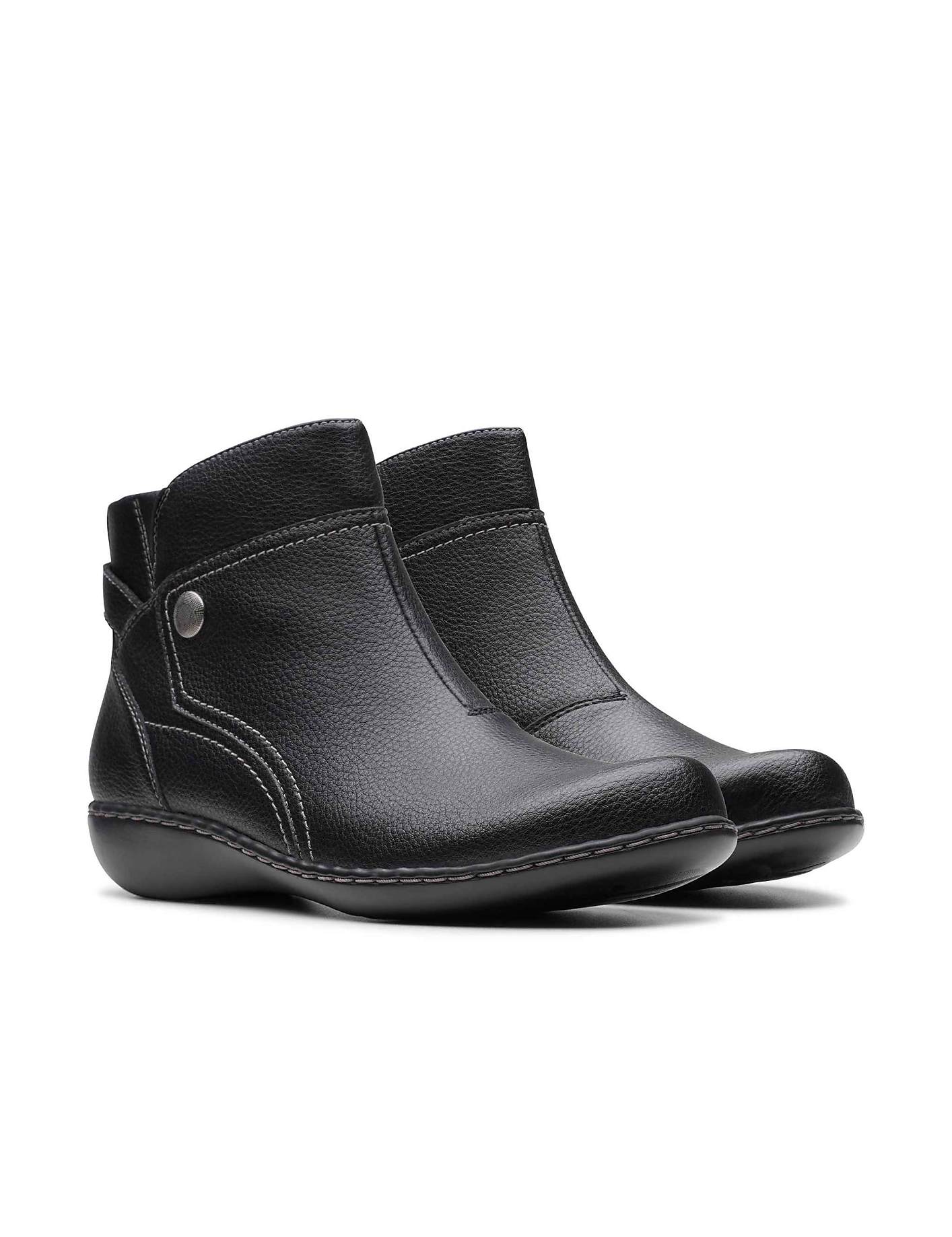 A pair of black leather ankle boots sits against a plain white background. Product Image 5