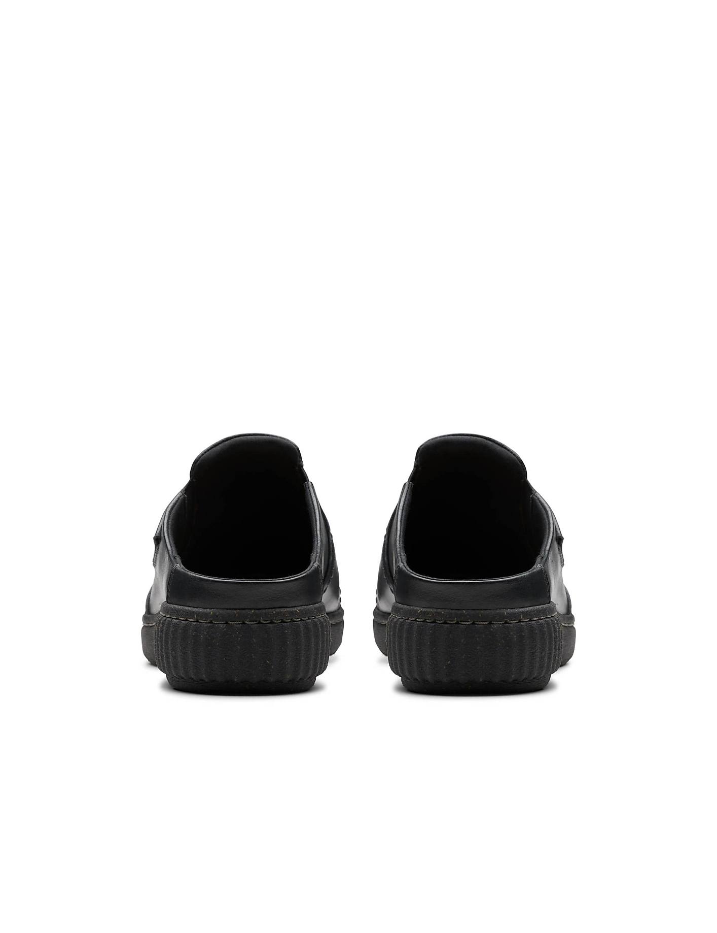 A pair of black slip-on shoes is positioned in the foreground against a plain white background. Product Image 2