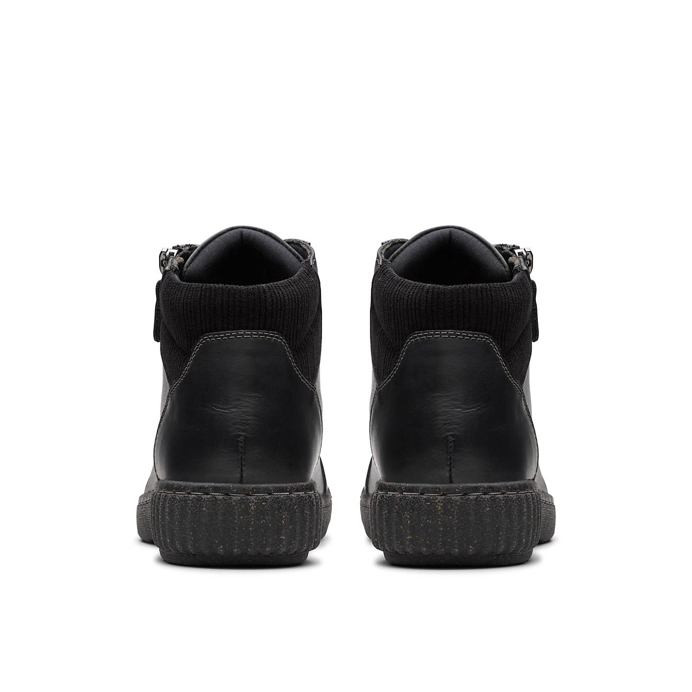 A pair of black leather ankle boots are positioned in the foreground against a plain white background. Product Image 2