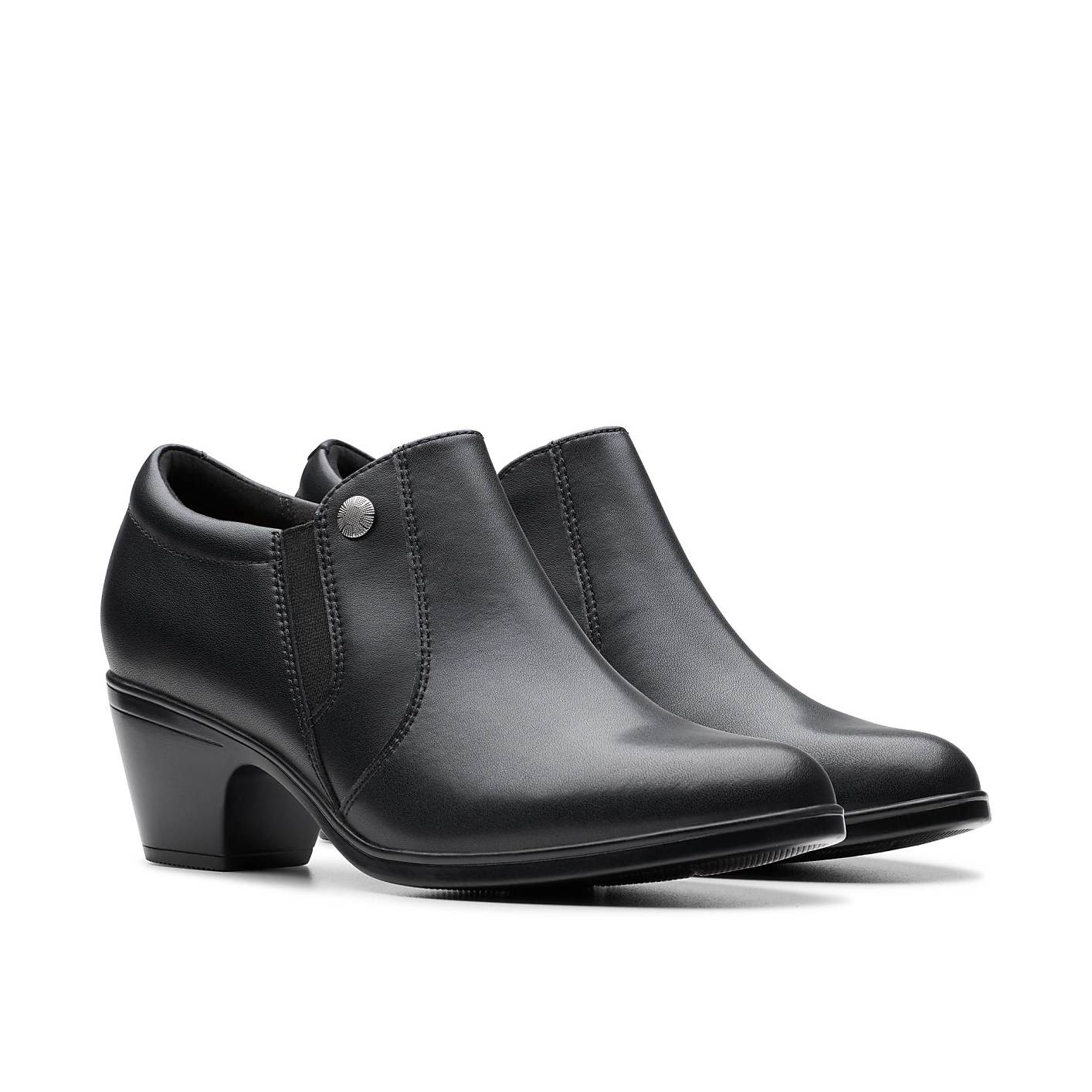 A pair of black leather ankle boots with block heels sits against a plain white background. Product Image 5