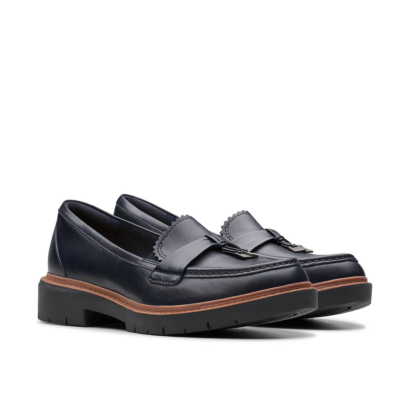 A pair of dark blue leather loafers with thick lug soles sits against a plain white background. Product Image 5