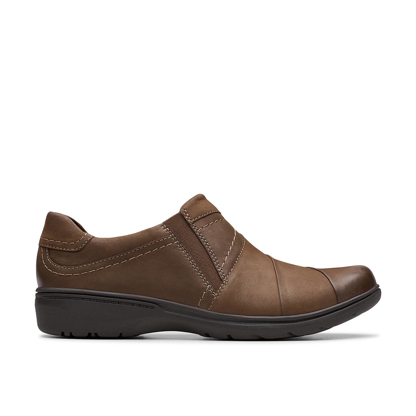 A single brown leather slip-on shoe sits in the foreground against a plain white background. Product Image 1