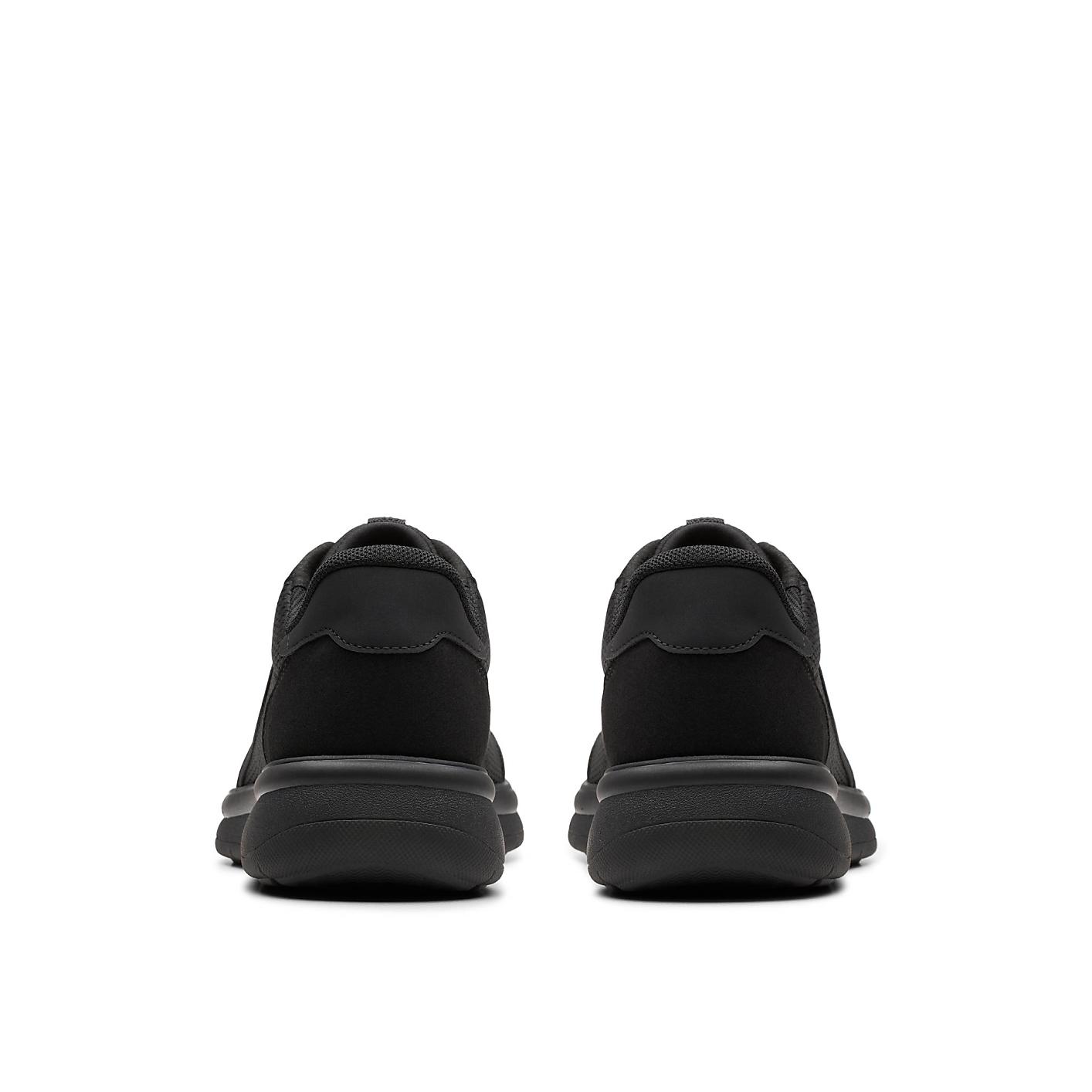 A pair of black sneakers is positioned in the foreground against a plain white background. Product Image 2