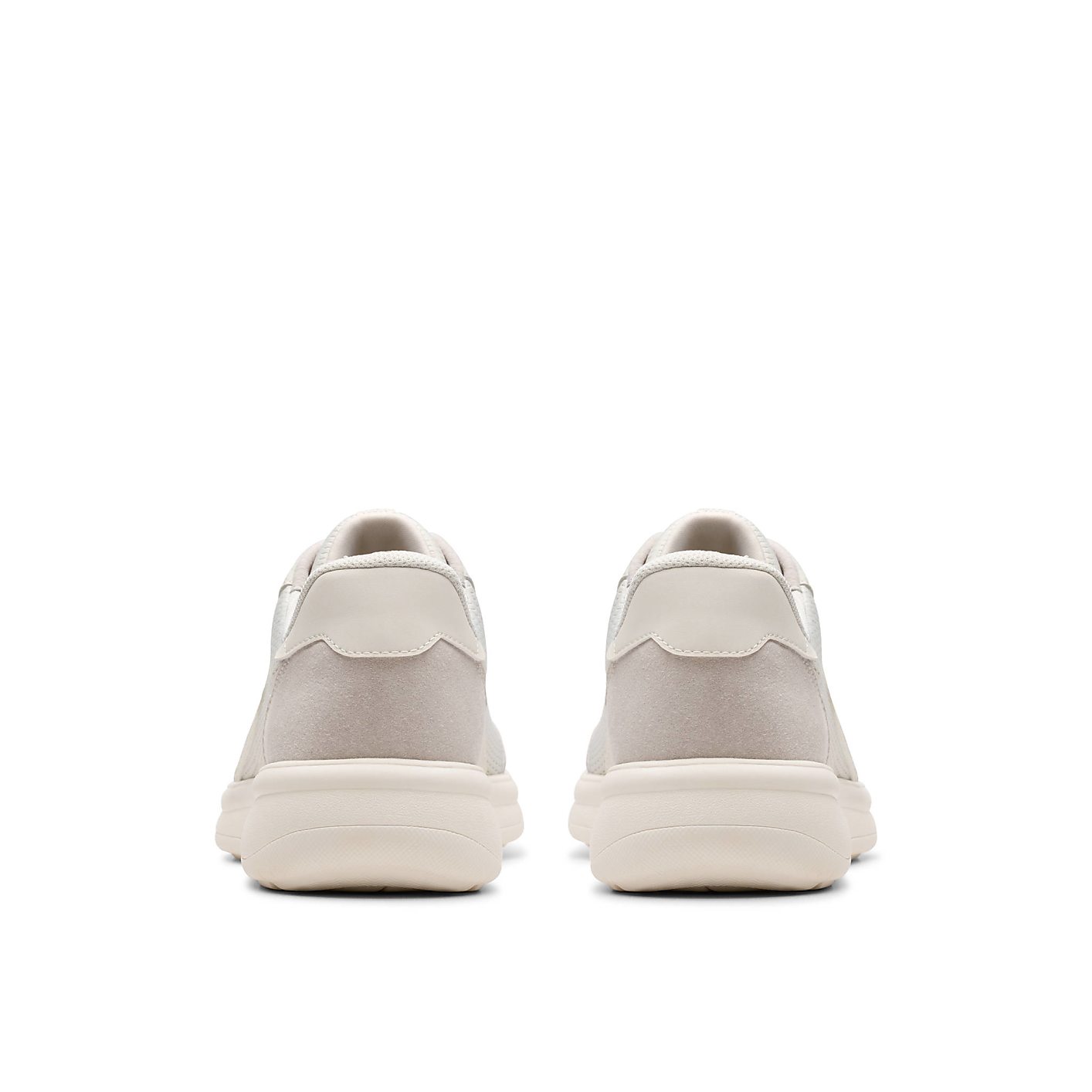 A pair of beige sneakers are positioned side-by-side in the foreground against a plain white background. Product Image 2