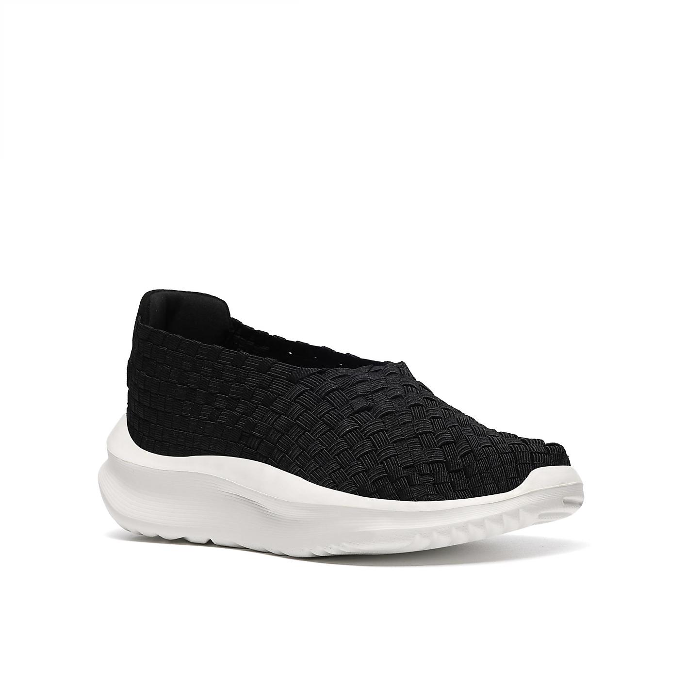 A black woven slip-on shoe with a thick white sole sits against a plain white background. Product Image 5