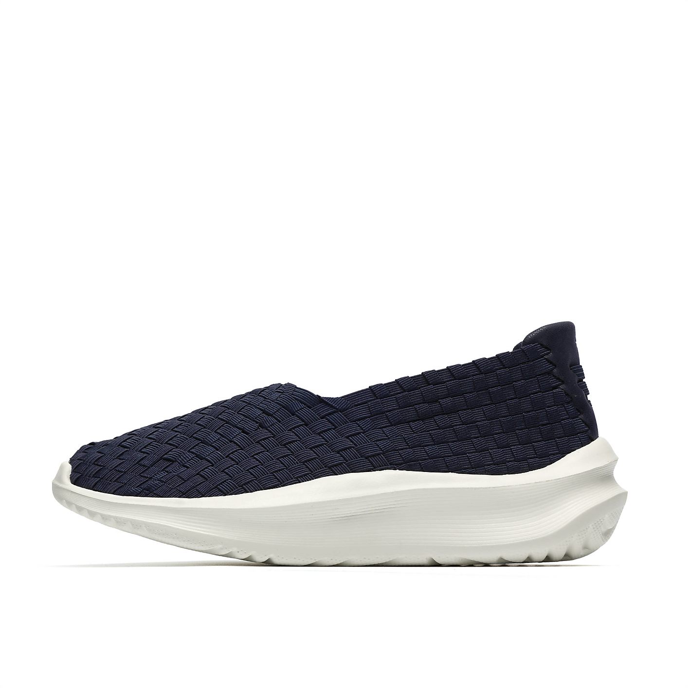 A navy blue woven slip-on shoe with a thick white sole sits against a plain white background. Product Image 3