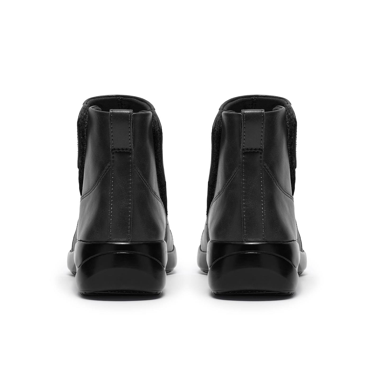 A pair of black leather Chelsea boots are positioned side-by-side against a plain white background. Product Image 2
