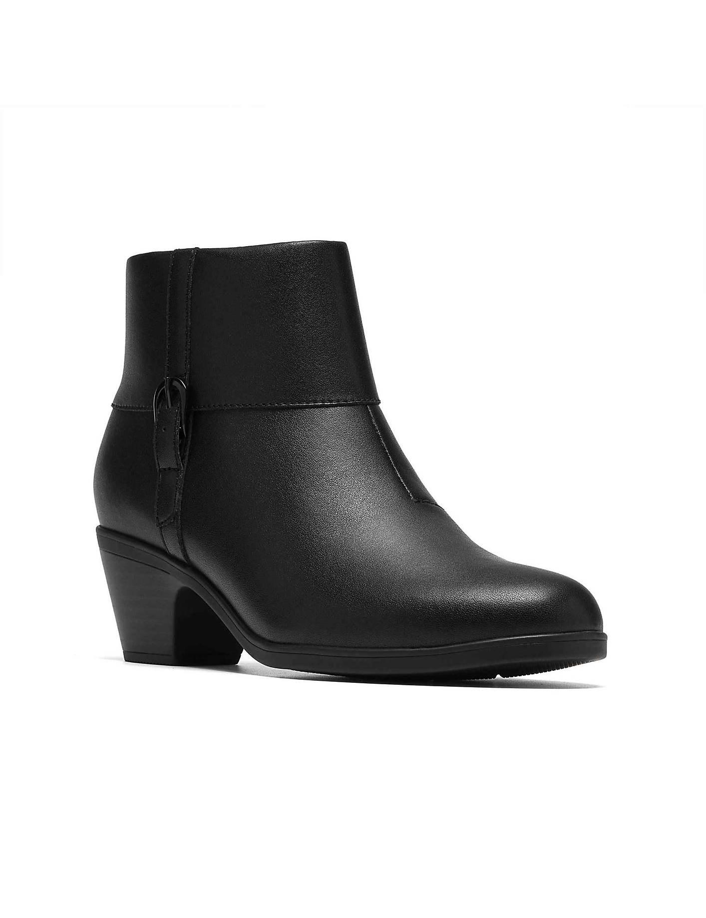A black leather ankle boot with a block heel stands centered against a plain white background. Product Image 5