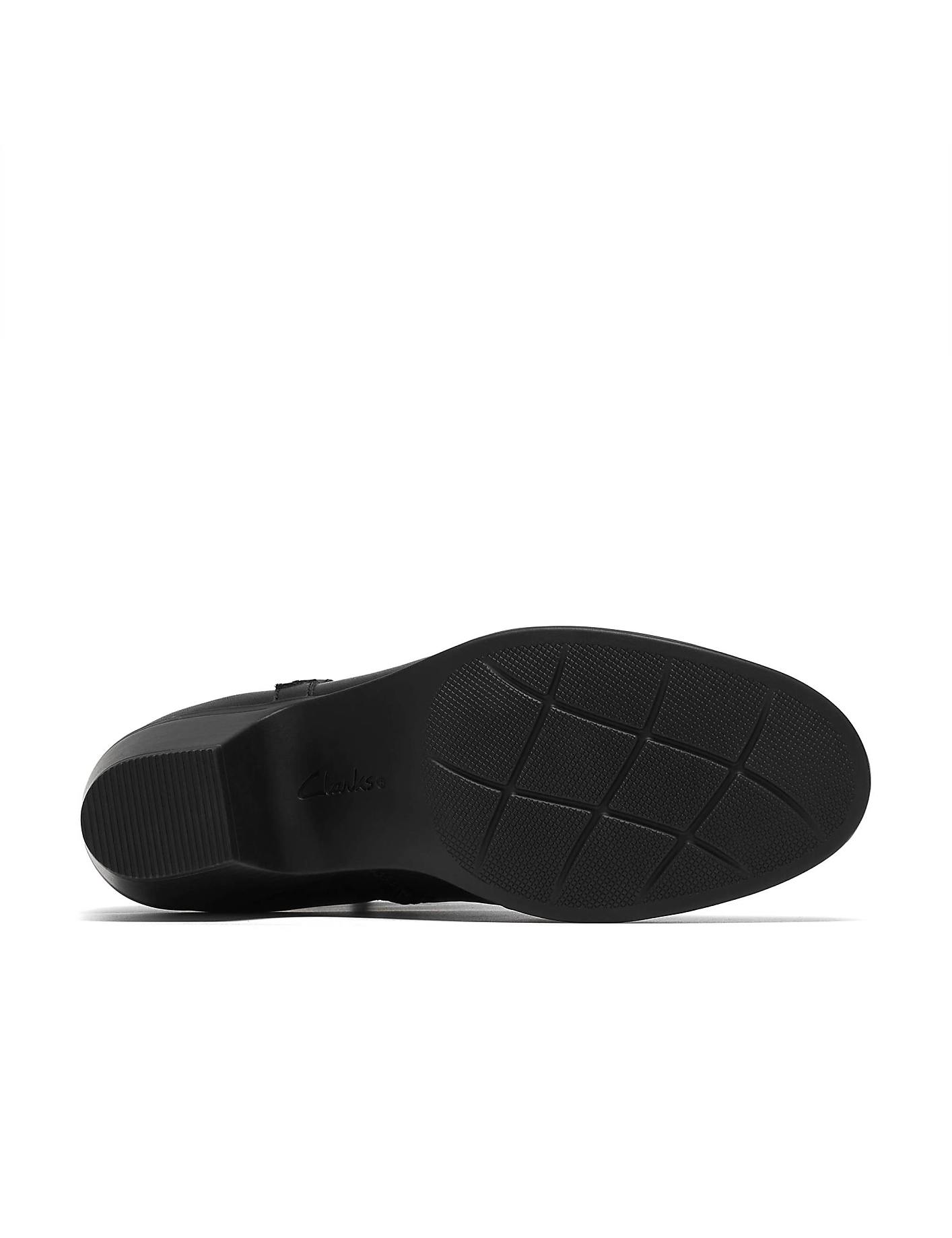 A black Clarks shoe is positioned in the foreground against a plain white background. Product Image 4