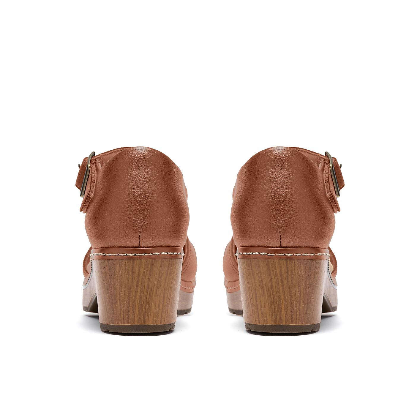 A pair of brown leather heeled sandals are positioned centrally against a plain white background. Product Image 2