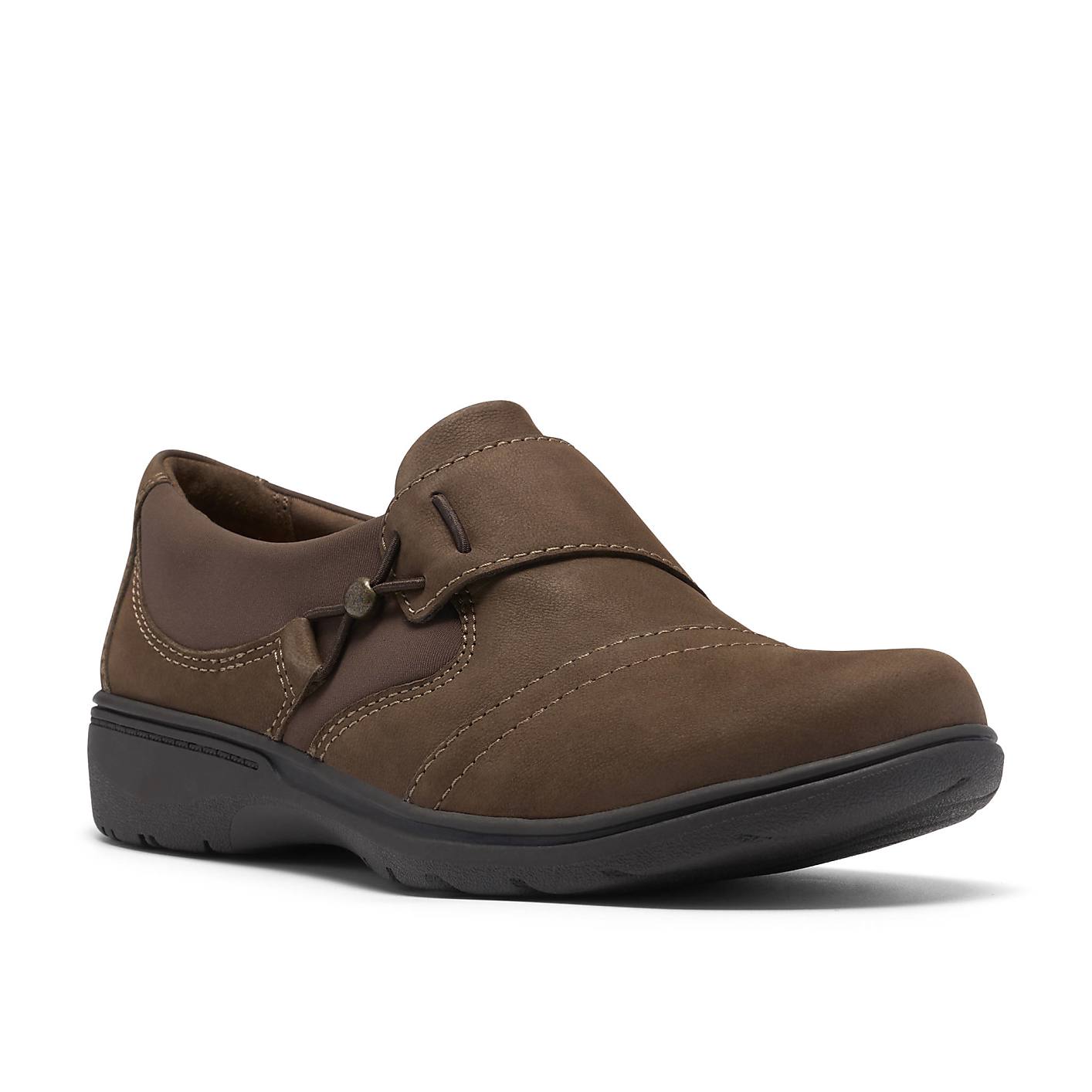A brown leather slip-on shoe sits in the foreground against a plain white background. Product Image 5