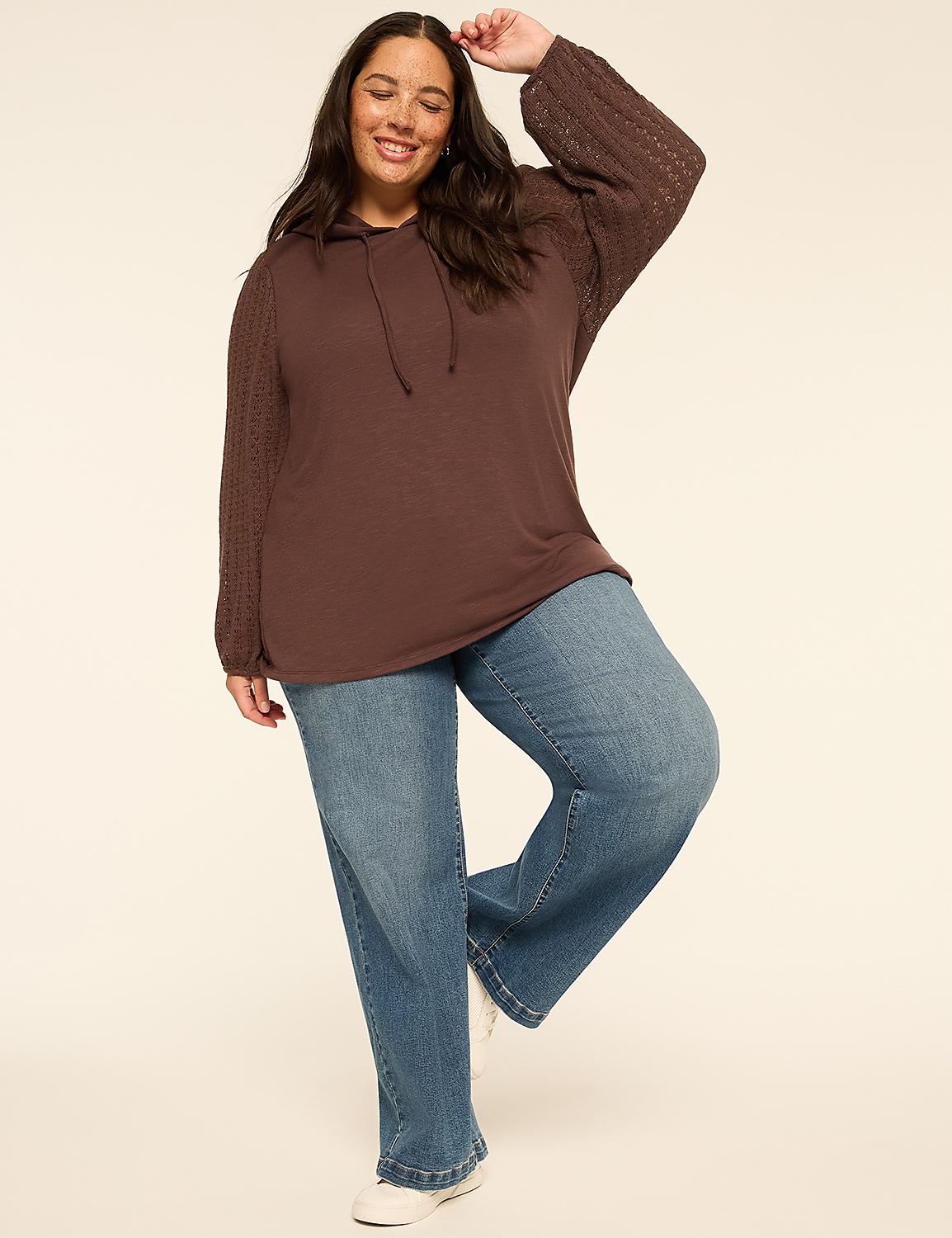 A smiling woman in a brown hoodie and light blue jeans stands against a plain, light-colored background. Product Image 3