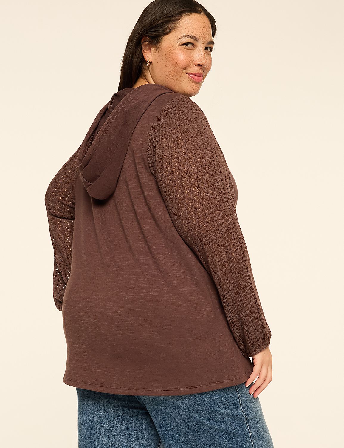 A woman in a brown hooded sweatshirt with lace sleeves smiles over her shoulder against a plain beige background. Product Image 2